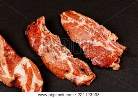 Meat. Raw pieces of pork with a black background. Selective focus. Top view. raw and fresh pork meat