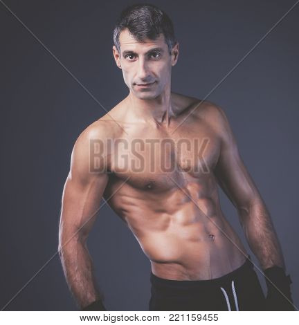 portrait of hand wrapping half nude boxer