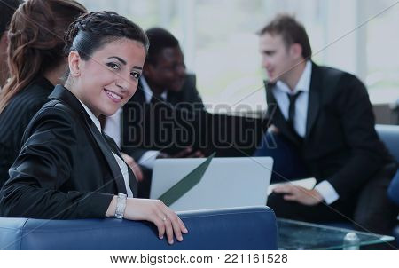 Young business woman standing with her co-wokers in background