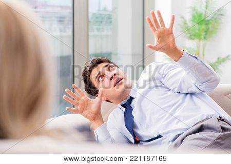 Young man visiting psychiatrist doctor for consultation