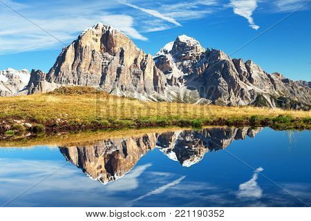 View from passo Giau, Tofana or Le Tofane Gruppe, mountain mirroring in lake, Dolomites, Italy