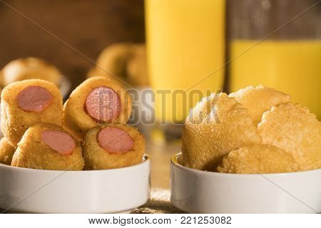 Mixed brazilian snack on wood background. Salgadinhos.