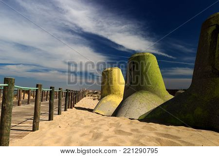Colorful pylons standing at Silvalde's beach in a warm morning