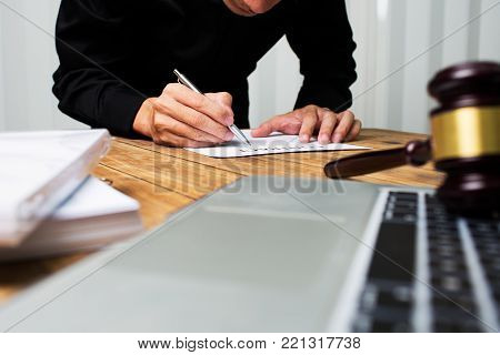 Young lawyer working hard alone in his office.