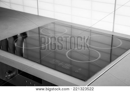 New electric stove with induction cooktop in kitchen, closeup