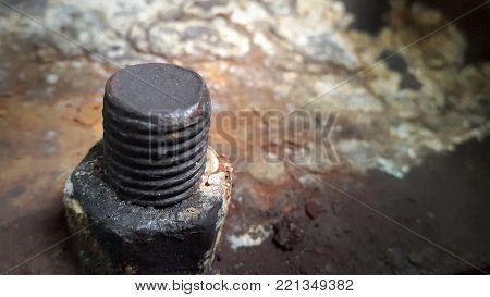 Corrosive rusted bolt with nut. Grunge industrial construction close up.