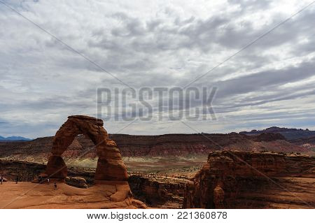 Delicate arch is a key feature, one of the largest stone arches in Arches National Park, Utah, USA. This image is from a slightly cloudy late august afternoon.