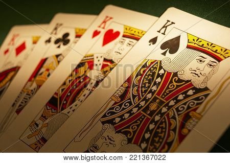 CLECKHEATON, WEST YORKSHRE, UK: HAND OF PLAYING CARDS DISPLAYING FOUR KINGS ON GREEN CLOTH GAMING TABLE, CIRCA 2007, CLECKHEATON, WEST YORKSHIRE, UK