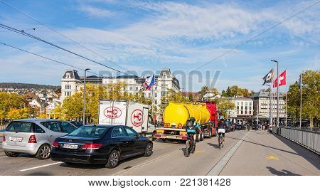 Zurich, Switzerland - 29 September, 2017: traffic on Quaibrucke bridge, buildings at Bellevue square in the background. Zurich is the largest city in Switzerland and the capital of the Swiss canton of Zurich.