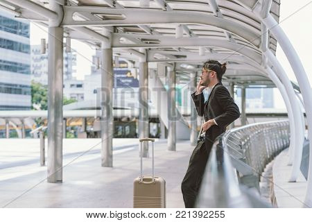woman traveler walking with suitcase at airport corridor