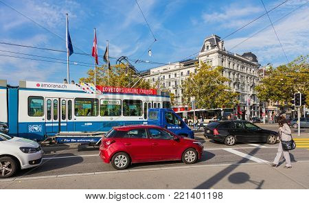 Zurich, Switzerland - 29 September, 2017: traffic on Quaibrucke bridge, buildings at Bellevue square in the background. Zurich is the largest city in Switzerland and the capital of the Swiss canton of Zurich.