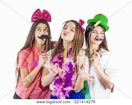 Portrait of three beautiful girls with festive make-up, hairstyle, accessories, props