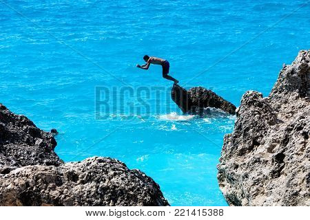 People Swim In The Sea At The Megali Petra Beach In Lefkada Island, Greece