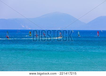 People Swim In The Sea At The Megali Petra Beach In Lefkada Island, Greece