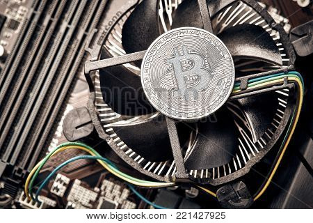 Bitcoin. New virtual money. Bitcoins lie on the video card, concept of mining. Flat lay. Top view. Still life