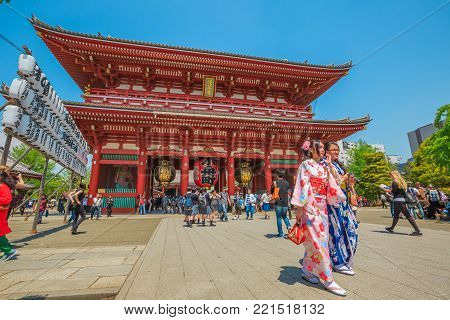 Tokyo, Japan - April 19, 2017: young women in traditional japanese kimonos coming out of the Hozomon, Treasure-House Gate, theentrance of Buddhist Temple Senso-ji, Asakusa, the oldest temple in Tokyo.