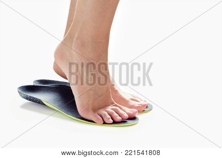 female feet stand on their toes in orthopedic insoles