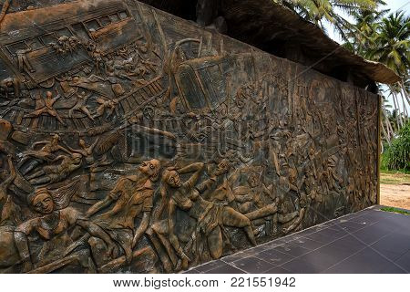 HIKKADUWA, SRI LANKA, CIRCA DECEMBER 2013: Close up bas-relief of monument to tsunami victims of 2004