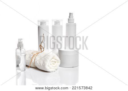 Set of cosmetic products in white containers on light background. Still life. Copy space. Place for your brand