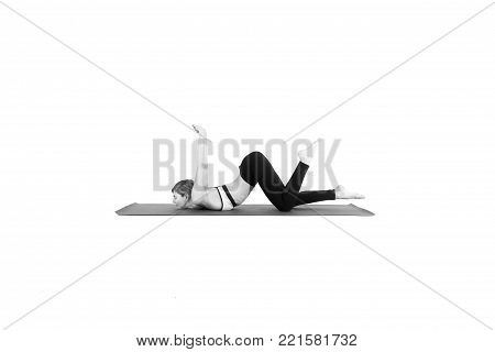 Sporty young woman doing yoga practice isolated on white background - concept of healthy life and natural balance between body and mental development