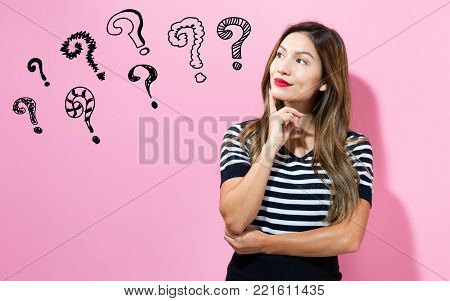 Question Marks with young woman in a thoughtful pose