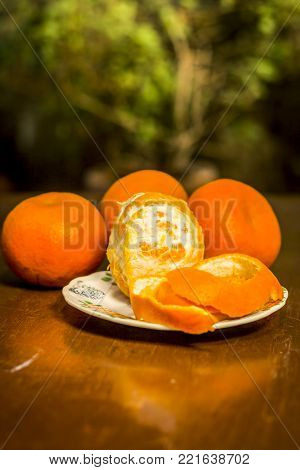 Close Up Of Fresh Ripe Oranges,citrus Aurantium In A Plate On Wooden Surface.