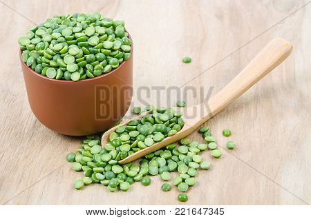 The Green split peas on wooden background.