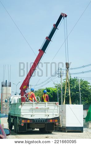 white crane truck raise the generator on floor in site construction with man worker