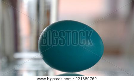 Blue easter egg on blurry background for easter card
