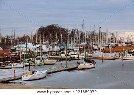 Panorama of the port Small private yachts pier in winter boats in blue sky in background.