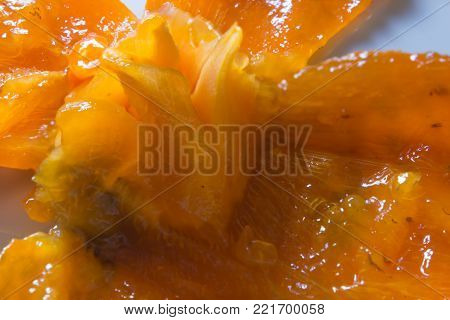 Macro of a persimmon peel on a dish