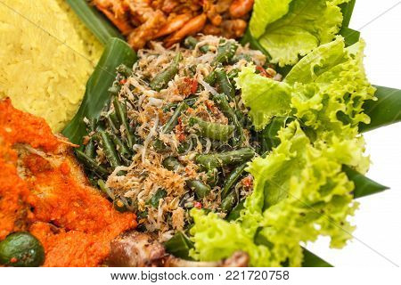 portrait of traditional indonesian food, urap on nasi tumpeng