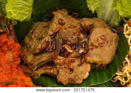 close up portrait of indonesian dish rendang on nasi tumpeng