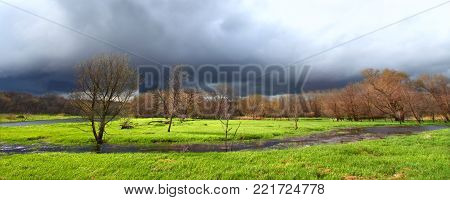 Dark clouds precede a spring thunderstorm over an Illinois wetland
