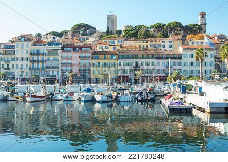 Cannes, France - November 21, 2017: luxury boats in the marina with Le Sequet old town in tha background
