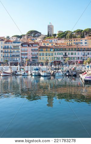 Cannes, France - November 21, 2017: luxury boats in the marina with Le Sequet old town in tha background