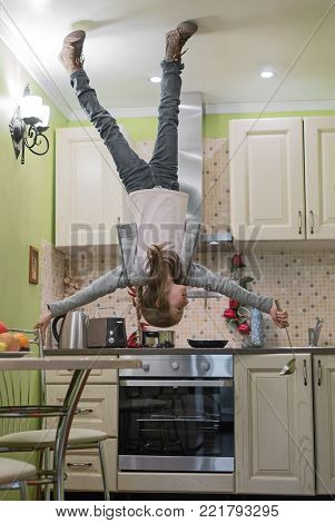 Upside Down House. Little Girl On The Kitchen.