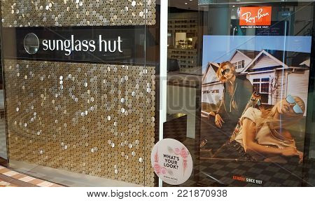 Sydney, Australia - November 03, 2017: Sunglass Hut retail store exterior with huge Ray-Ban advertisement poster on display.
