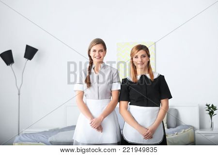 Young chambermaids in uniform indoors