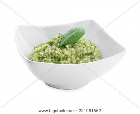 Dish with tasty spinach risotto on white background