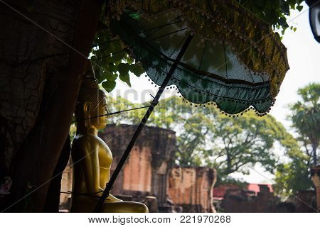 Golden Buddha statue in Prasat Wat Sa Kamphaeng Yai at Uthumphon Phisai District,Old Thai historical castle.