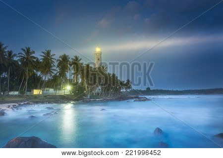 View of lighthouse Dondra and lights at night Matara, Sri Lanka