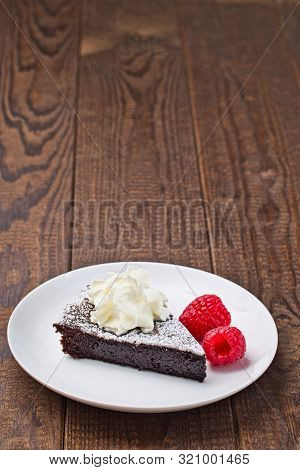 Piece Of Chocolate Sticky Brownie Cake, Swedish Dessert Kladdkaka, On The Plate, Garnished With Icin