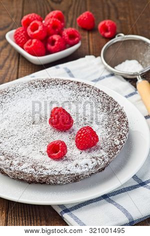 Chocolate Sticky Brownie Cake, Swedish Dessert Kladdkaka, On The Plate, Garnished With Icing Sugar A