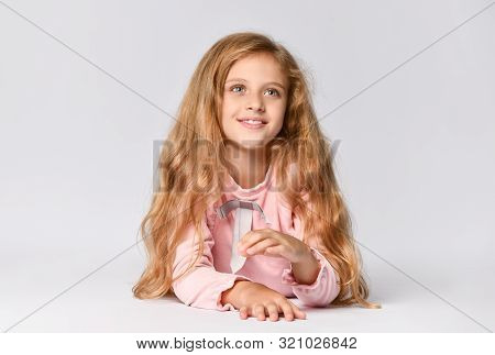 Portrait Of A Young Teenage Girl In A Long-sleeved Roh Dress And Matching Tone Gumshoes Lying On The