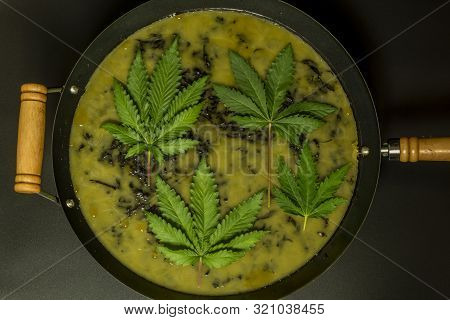 Making Of Marijuana Green Butter With Black Background In Wok