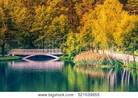 Old Small White Bridge Over Lake At Sunny Autumn Day