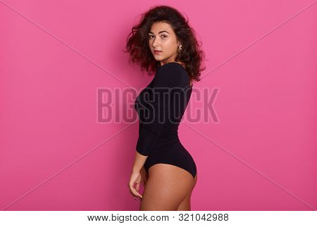 Profile Of Young Beautiful Woman Dresses Black Combidress, Posing Isolated Over Pink Background, Cha