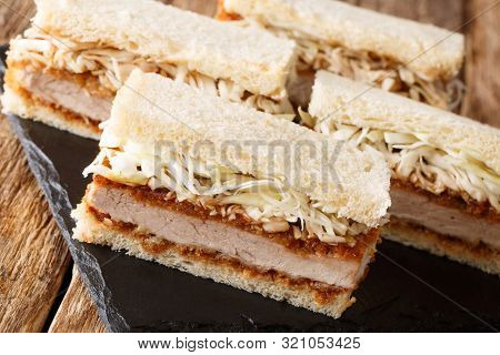 Katsu Sando Sandwiches With Pork Cutlet, Tonkatsu Sauce And Cabbage Closeup On A Slate Board. Horizo