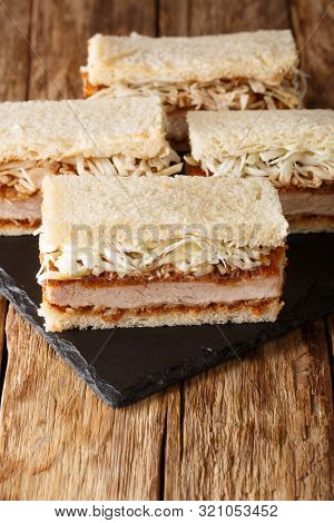 Sliced Japanese Katsu Sando Sandwiches With Tonkatsu Sauce And Cabbage Closeup On A Wooden Table. Ve